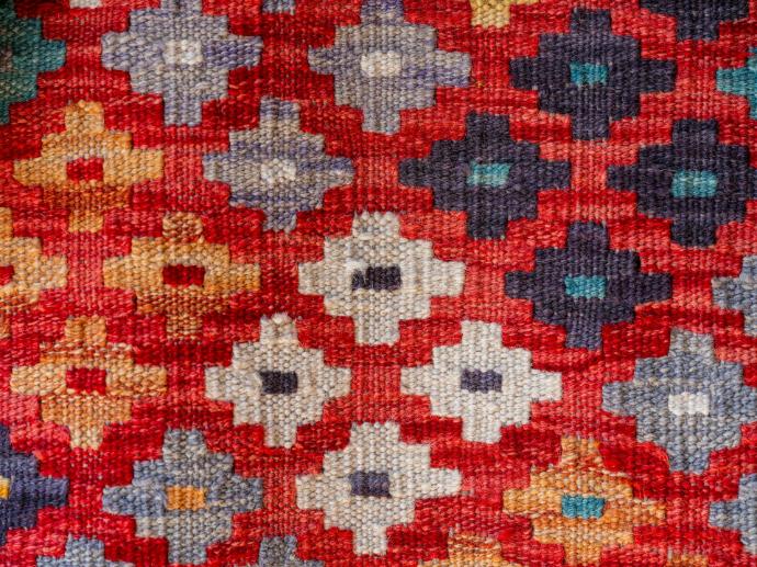 A close up of a red and blue quilt
